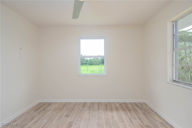 unfurnished room with a healthy amount of sunlight, ceiling fan, and light hardwood / wood-style floors