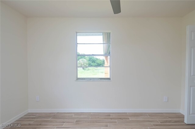 spare room featuring light hardwood / wood-style flooring and ceiling fan