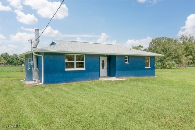 rear view of house with a yard