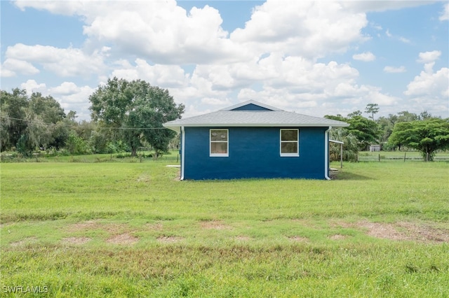 view of outbuilding featuring a yard