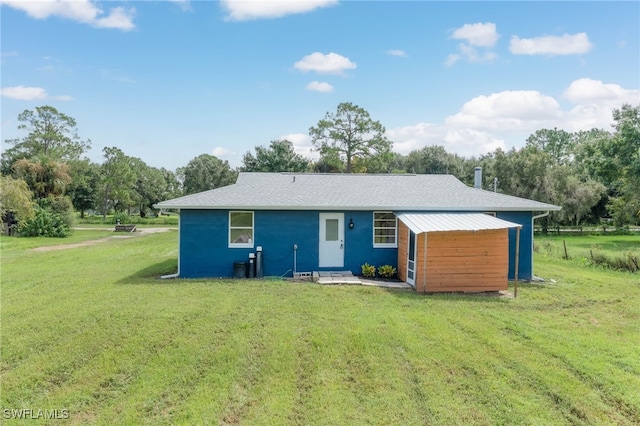 rear view of house with a yard and a carport