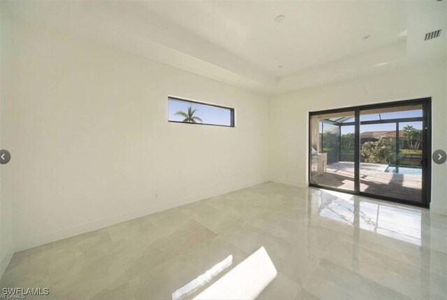 unfurnished room with a raised ceiling