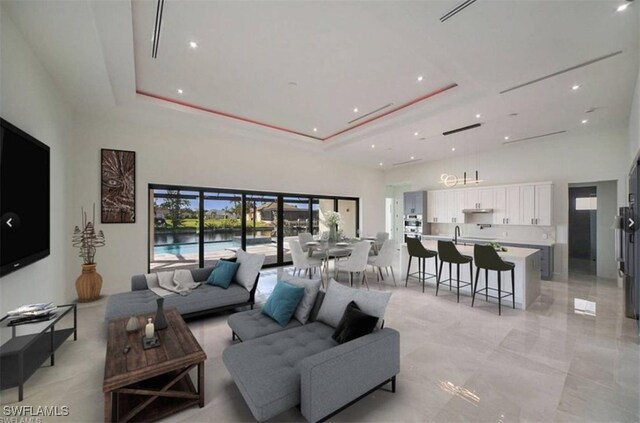 living room with a tray ceiling