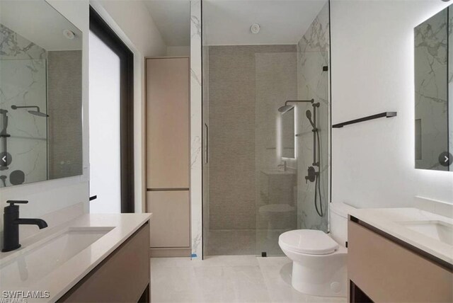 bathroom with tiled shower, vanity, toilet, and tile patterned flooring