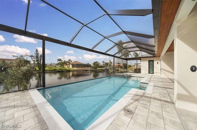 view of pool with a water view, a patio, and glass enclosure