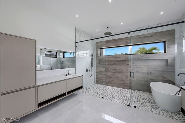 bathroom featuring shower with separate bathtub and vanity