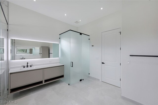 bathroom featuring walk in shower and vanity