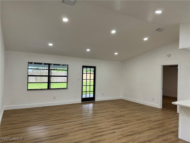 empty room with lofted ceiling and dark wood-type flooring