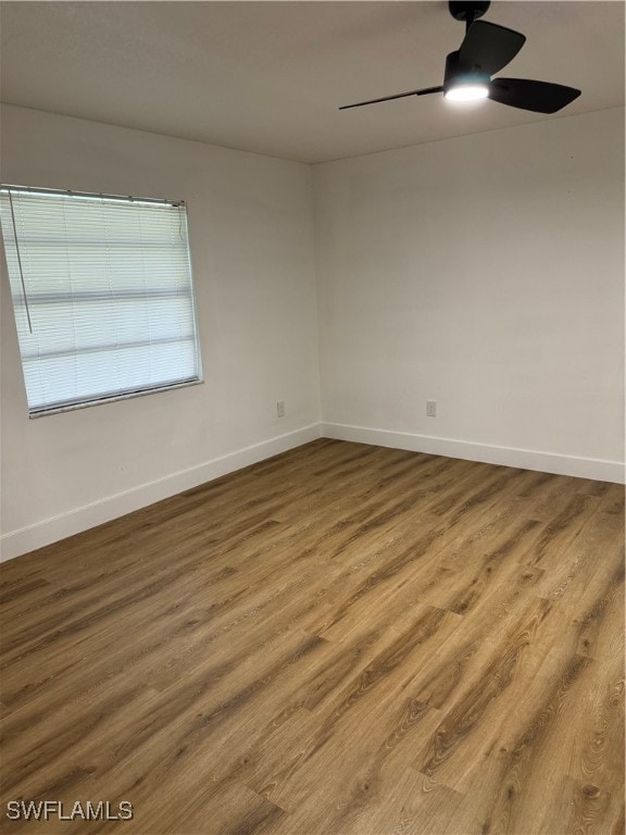 unfurnished room with hardwood / wood-style floors and ceiling fan