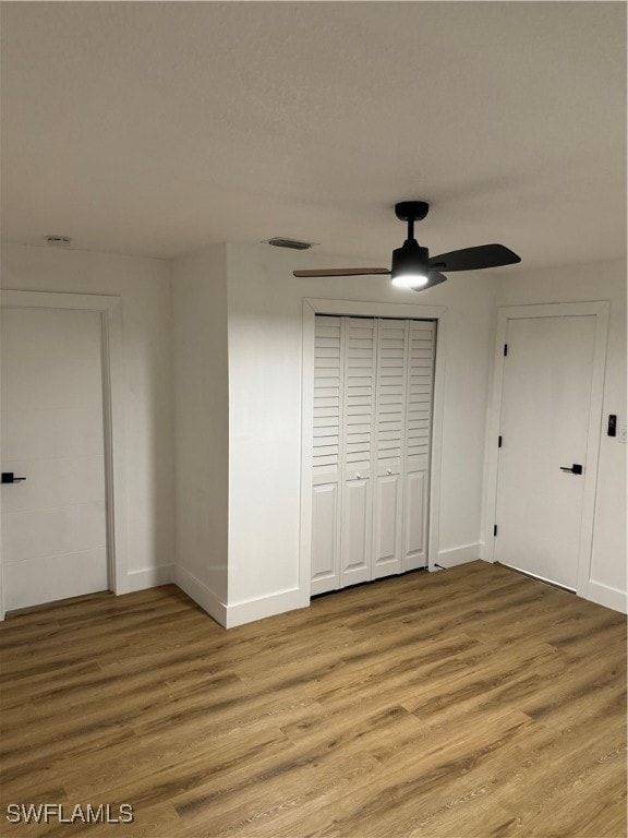 unfurnished bedroom with wood-type flooring and ceiling fan