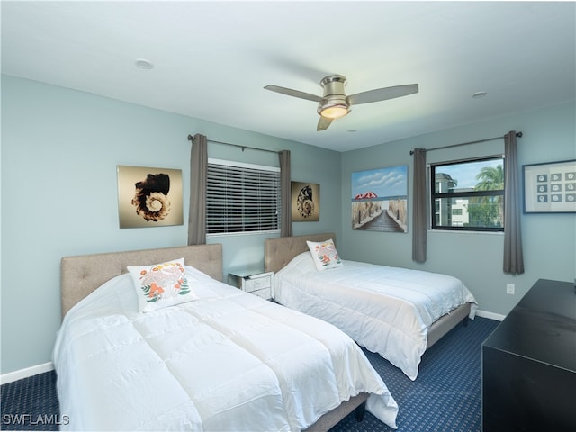 bedroom featuring ceiling fan and carpet