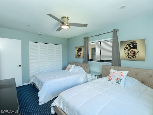 carpeted bedroom featuring ceiling fan and a closet