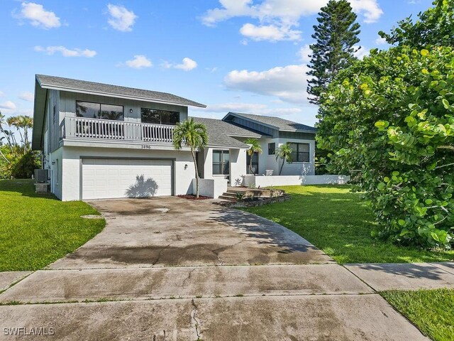 view of front of property featuring a balcony, a garage, a front lawn, and central air condition unit