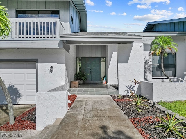 doorway to property featuring a garage and a balcony