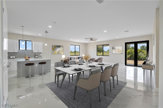 dining area with french doors and ceiling fan