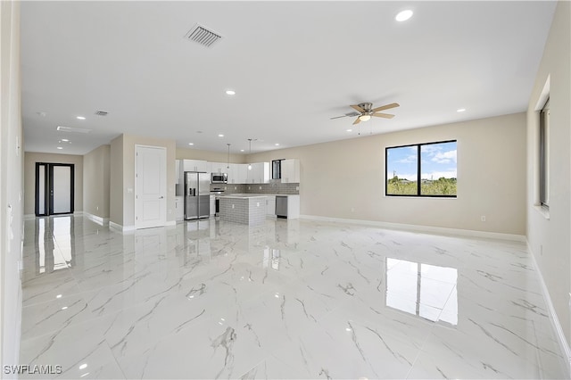 unfurnished living room featuring ceiling fan