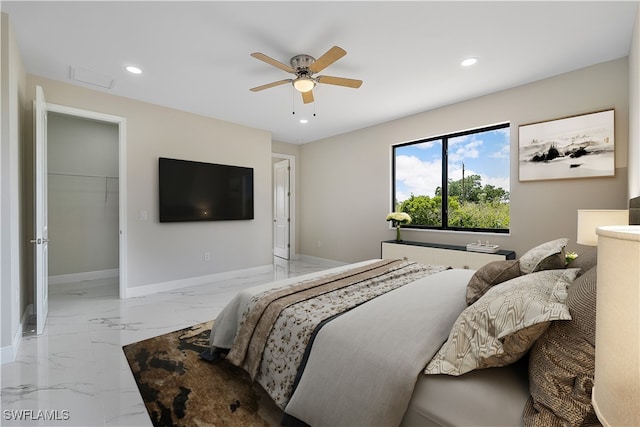 bedroom with a closet, ceiling fan, and a spacious closet