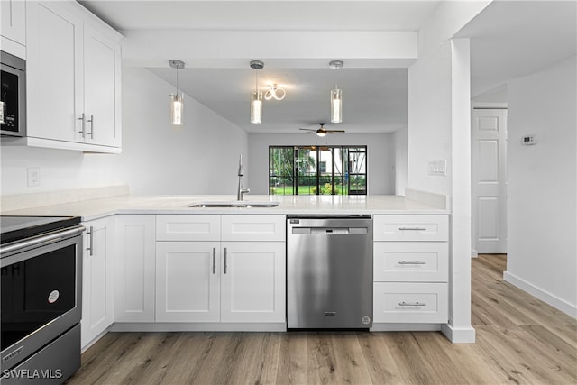 kitchen with stainless steel appliances, light wood-type flooring, sink, and white cabinetry