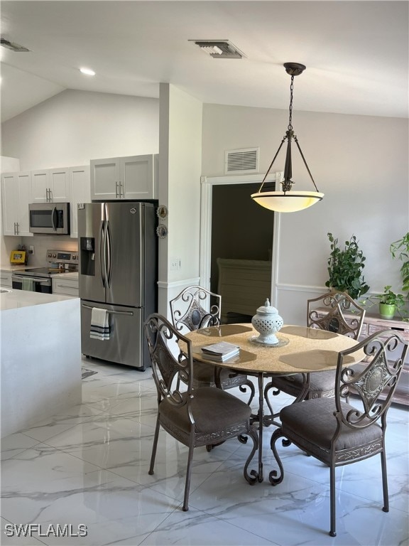 dining space featuring lofted ceiling