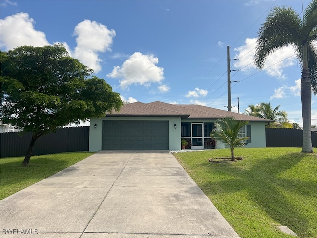 ranch-style house featuring fence, concrete driveway, a front yard, stucco siding, and a garage