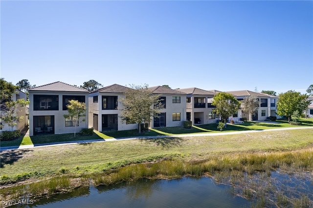 exterior space featuring a water view and a yard