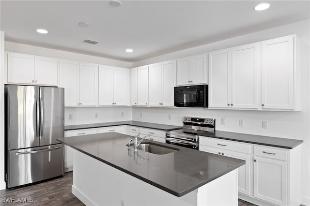 kitchen with white cabinets, sink, an island with sink, dark hardwood / wood-style flooring, and stainless steel appliances