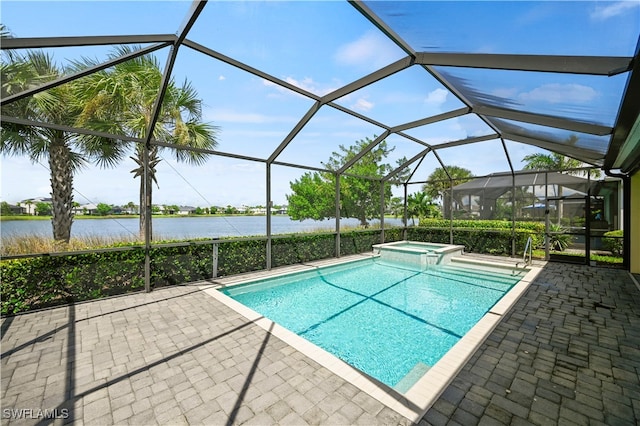 view of pool featuring glass enclosure, a patio area, and a water view