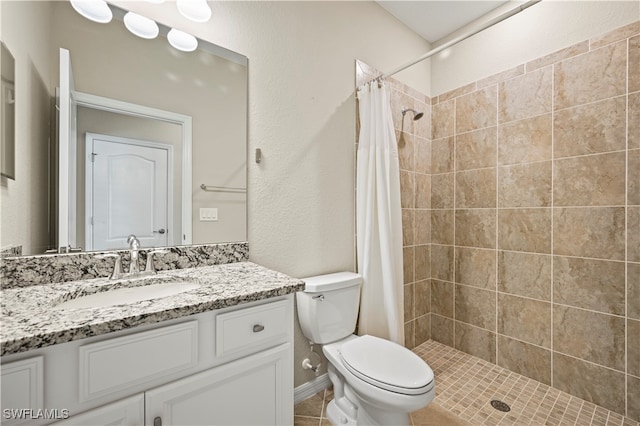 bathroom featuring tile patterned floors, a shower with shower curtain, toilet, and vanity