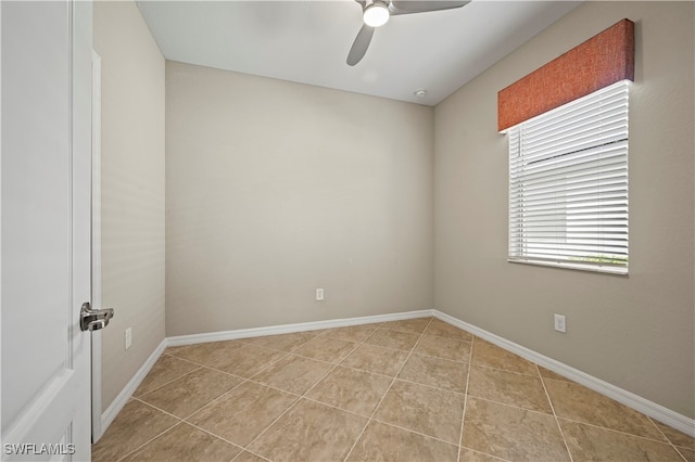 tiled empty room with ceiling fan