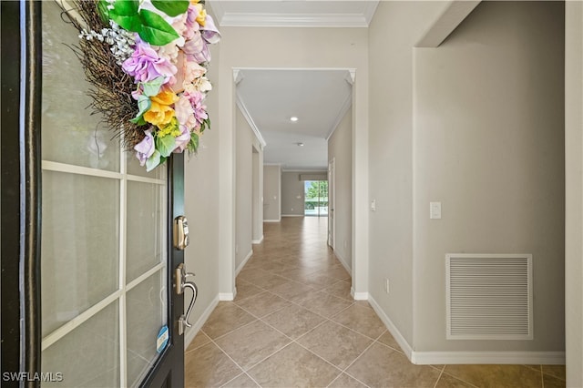 corridor with ornamental molding and light tile patterned floors