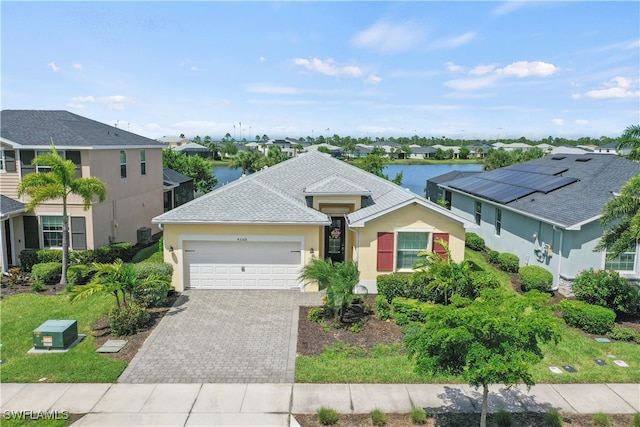 view of front of property featuring a water view and a garage