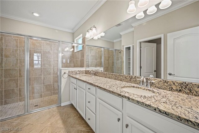 bathroom featuring ornamental molding, vanity, and a shower with door