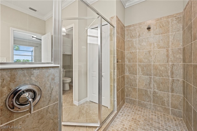 bathroom featuring tile patterned flooring, walk in shower, toilet, and ornamental molding