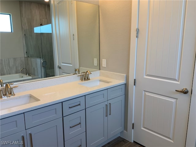 bathroom with independent shower and bath, vanity, and wood-type flooring