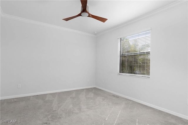 carpeted spare room featuring crown molding and ceiling fan