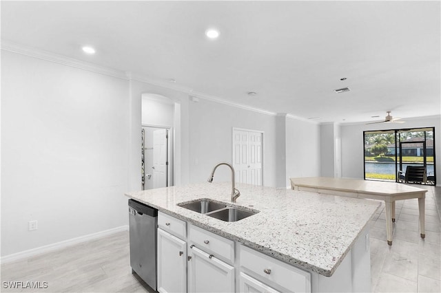 kitchen featuring white cabinetry, an island with sink, sink, stainless steel dishwasher, and light stone counters