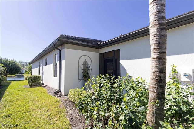 view of side of home with a lawn