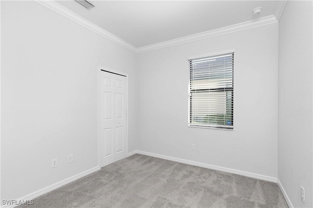 carpeted spare room with ornamental molding