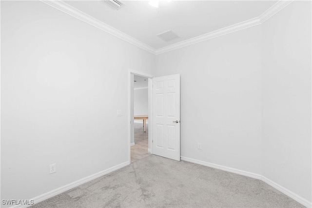 carpeted spare room with crown molding