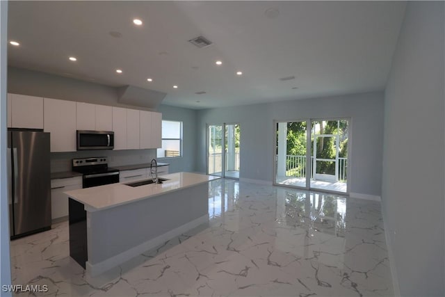 kitchen featuring visible vents, marble finish floor, stainless steel appliances, and a sink