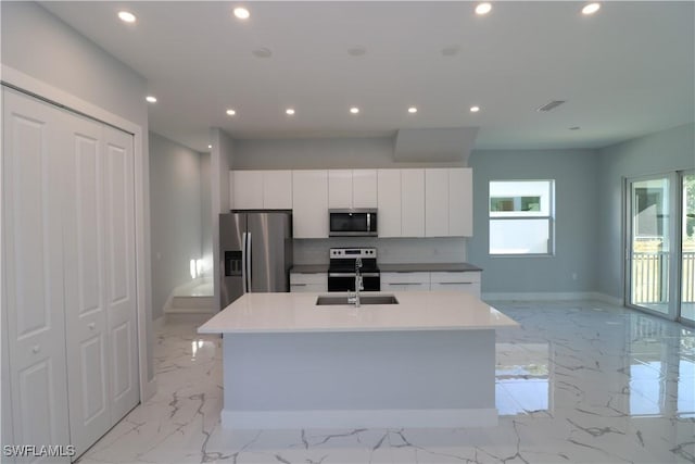 kitchen featuring a sink, stainless steel appliances, marble finish floor, and recessed lighting