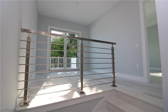 stairway with vaulted ceiling