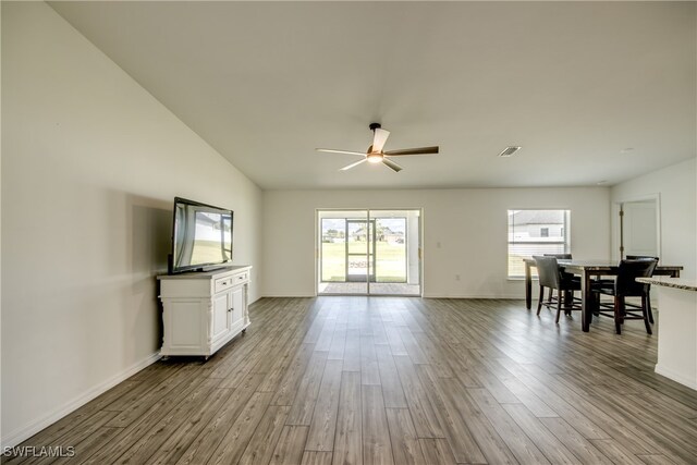 unfurnished living room featuring ceiling fan, hardwood / wood-style flooring, and vaulted ceiling