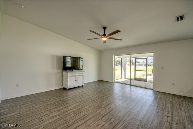 unfurnished living room featuring vaulted ceiling, hardwood / wood-style floors, and ceiling fan