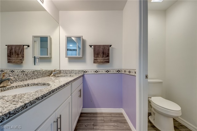 bathroom featuring hardwood / wood-style floors, toilet, and vanity