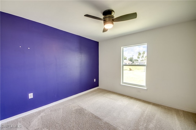 spare room with carpet flooring and ceiling fan