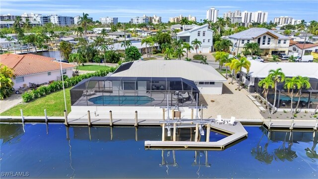 exterior space with a lanai and a water view