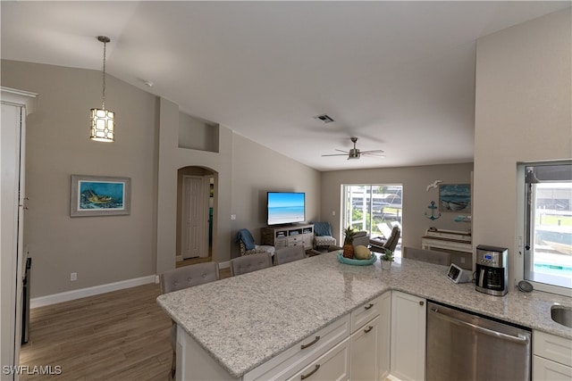 kitchen featuring lofted ceiling, a peninsula, visible vents, white cabinetry, and stainless steel dishwasher