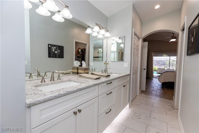 full bathroom featuring marble finish floor, ensuite bath, a sink, and a ceiling fan