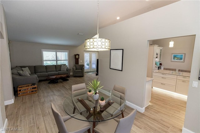 dining room featuring light wood-style flooring and baseboards